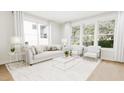 Bright and airy living room with large windows and comfortable seating at 4081 Elk Creek Ln # 07, Raleigh, NC 27612