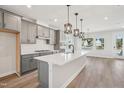 Open kitchen featuring a large island, gray cabinets, and stainless steel appliances at 515 Wendover Pkwy, Pittsboro, NC 27312