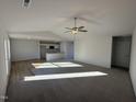 Open living room with vaulted ceiling and kitchen view at 52 Faucette Dr, Selma, NC 27576