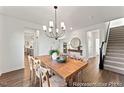Spacious dining room with hardwood floors, large table, and chandelier at 292 Nathan Dr # 46P, Lillington, NC 27546