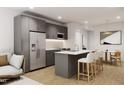 Open concept kitchen featuring gray cabinets and a breakfast bar at 711 E Lenoir St # 207, Raleigh, NC 27601
