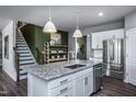 Kitchen with white cabinets, granite island, and stainless steel appliances at 769 Denburn Pl, Raleigh, NC 27603