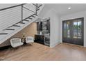 Modern basement bar with dark cabinetry, comfortable seating, and a wine cooler at 8001 Wexford Waters Ln, Wake Forest, NC 27587