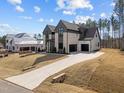 Spacious home featuring a modern design, a three car garage, and a long driveway on a large lot at 8001 Wexford Waters Ln, Wake Forest, NC 27587