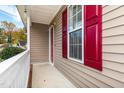 Front porch with red shutters and white railing at 125 Havencrest Lndg, Garner, NC 27529