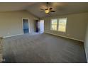 Open living area with neutral colors and ceiling fan at 128 Pate Landing Dr, Selma, NC 27576