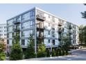 Modern apartment building with light colored metal panels and multiple balconies at 1300 St Marys St # 403, Raleigh, NC 27605