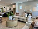Bright living room featuring a comfortable sofa, stylish decor, and an open floor plan to the kitchen at 1364 Barreto Dr, Wendell, NC 27591