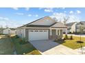 Gray Craftsman style home with white garage door and landscaping at 14 Baird Cv Ln, Angier, NC 27501