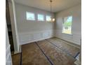 Bright dining room with decorative molding and modern chandelier, ready for your personal touch at 14 E American Marigold Dr # 65, Benson, NC 27504