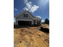 Charming new construction home with gray siding and an attached two-car garage at 14 E American Marigold Dr # 65, Benson, NC 27504