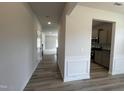 Inviting hallway with wood-look floors, leading to the kitchen and living area of the home at 14 E American Marigold Dr # 65, Benson, NC 27504