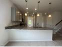 Stylish kitchen featuring granite counters, stainless appliances, and pendant lighting, creating a chef's dream at 14 E American Marigold Dr # 65, Benson, NC 27504