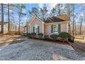 House exterior showcasing a side view and gravel driveway at 204 Percheron Dr, Zebulon, NC 27597