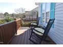 Inviting front porch with classic rocking chairs, offering a cozy outdoor space for relaxation with a glimpse of the neighborhood at 216 Parrish Farm Lane Ln, Benson, NC 27504