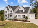 Two-story home with a large, attached garage, and nicely landscaped lawn at 2404 Toll Mill Ct, Raleigh, NC 27606