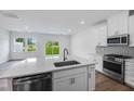 Bright kitchen with white cabinets, stainless steel appliances, and a large island at 8703 Wardle Ct, Wake Forest, NC 27587