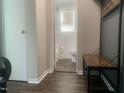 A sleek bathroom view with tile details, a toilet, and a coat rack adding functional style to the space at 943 St Marys St # B, Raleigh, NC 27605