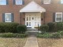 Close up view of entry to a brick building featuring white doors and a small white portico above at 943 St Marys St # B, Raleigh, NC 27605