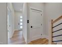 Light-colored hallway with hardwood floors and neutral walls at 1016 Manor Way, Durham, NC 27701