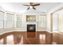 Bright living room with a cozy fireplace, hardwood floors, and natural light streaming through the windows at 10511 Sablewood Dr # 110, Raleigh, NC 27617