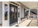 Modern front door with sidelights and a covered porch at 117 Sunburst Ct, Fuquay Varina, NC 27526