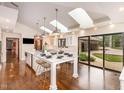 A bright, spacious kitchen featuring a large island with skylights above and a sliding glass door at 12044 Iredell, Chapel Hill, NC 27517