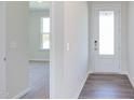 Bright entryway with white door and gray vinyl plank flooring at 121 Barn Door Dr, Lillington, NC 27546