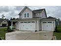 Two-story house with beige siding, white trim, and a three-car garage at 128 Baird Cv Ln, Angier, NC 27501