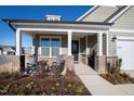 Inviting front porch with rocking chairs, brick columns, and landscaping at 1626 Plover Cir, Fuquay Varina, NC 27526