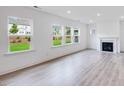 Bright living room with a fireplace, large windows, and wood flooring at 1705 Clydner Dr, Cary, NC 27523