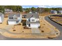 Aerial view of a beautiful two-story home showcasing a wide driveway and a manicured front yard at 20 Windflower Ct, Clayton, NC 27520