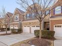 Townhome community featuring multiple brick townhomes with garages at 222 Kylemore Cir, Cary, NC 27513