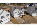 Two-story house in a neighborhood, featuring gray siding and a two-car garage at 34 Windflower Ct, Clayton, NC 27520