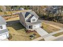 Two-story house with beige siding, white trim, and a two-car garage at 36 Railcar Way, Clayton, NC 27520