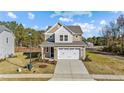 Two-story house with beige siding, white trim, and a two-car garage at 36 Railcar Way, Clayton, NC 27520
