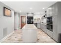 Contemporary kitchen with gray cabinets, granite counters, stainless steel appliances, and central island at 4236 Lake Ridge Dr, Raleigh, NC 27604