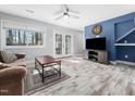 Cozy living room features neutral walls, a ceiling fan, and doors to the outside at 4236 Lake Ridge Dr, Raleigh, NC 27604