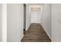 Long hallway with hardwood floors and chandelier at 4710 Flathead Pl, Fuquay Varina, NC 27526