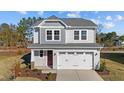 Two-story house with gray siding, red front door, and attached garage at 48 Railcar Way, Clayton, NC 27520