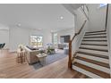 Bright, open living room with hardwood floors, contemporary furnishings, and natural light from sliding glass door at 645 Silvercomet Dr, Knightdale, NC 27545