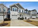 Two-story townhome with gray and white siding, two-car garage, and landscaping at 747 Creekway Dr, Fuquay Varina, NC 27526