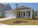Charming house with a two-car garage, landscaping, and a tree in the front yard at 76 Brooklynn Trl, Angier, NC 27501