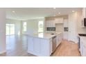 Modern kitchen with white cabinets, quartz countertops, and stainless steel appliances at 86 Barn Door Dr, Lillington, NC 27546
