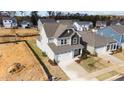 Two-story house with gray siding and a gray roof, in a new development at 86 Brooklynn Trl, Angier, NC 27501