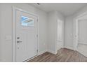Interior entryway with white door and wood-look flooring at 8798 Kenridge Ln, Fuquay Varina, NC 27526
