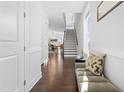 Bright entryway with hardwood floors, bench seating, and view of staircase at 931 Haybeck Ln, Apex, NC 27523