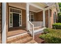 Inviting front porch with white railings and brick steps, leading to the home's entrance at 107 Myers Farm Ct, Cary, NC 27519