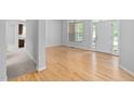 Bright, airy living room with hardwood floors and a large window, creating a warm atmosphere at 107 Myers Farm Ct, Cary, NC 27519