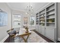 Bright home office with built-in shelves and a large desk at 1113 Magnolia Bend Loop, Cary, NC 27519